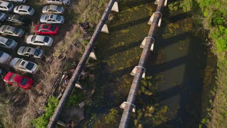 Fayetteville-Express-gas-pipeline-leading-along-rusting-old-cars-and-wetlands