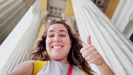 low angle selfie of woman amidst zappeion hall columns