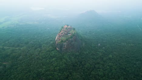 distinctive sigiriya lions rock in heart of forest at sunset time, sri lanka