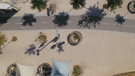 bicycles cross the frame and people relaxing - neve tzedek tel aviv neighborhood - top down view