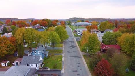 vibrant autumn trees in residential neighborhood in estrie, quebec, canada. aerial shot