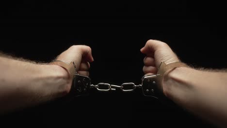 Man-breaking-free-from-handcuffs