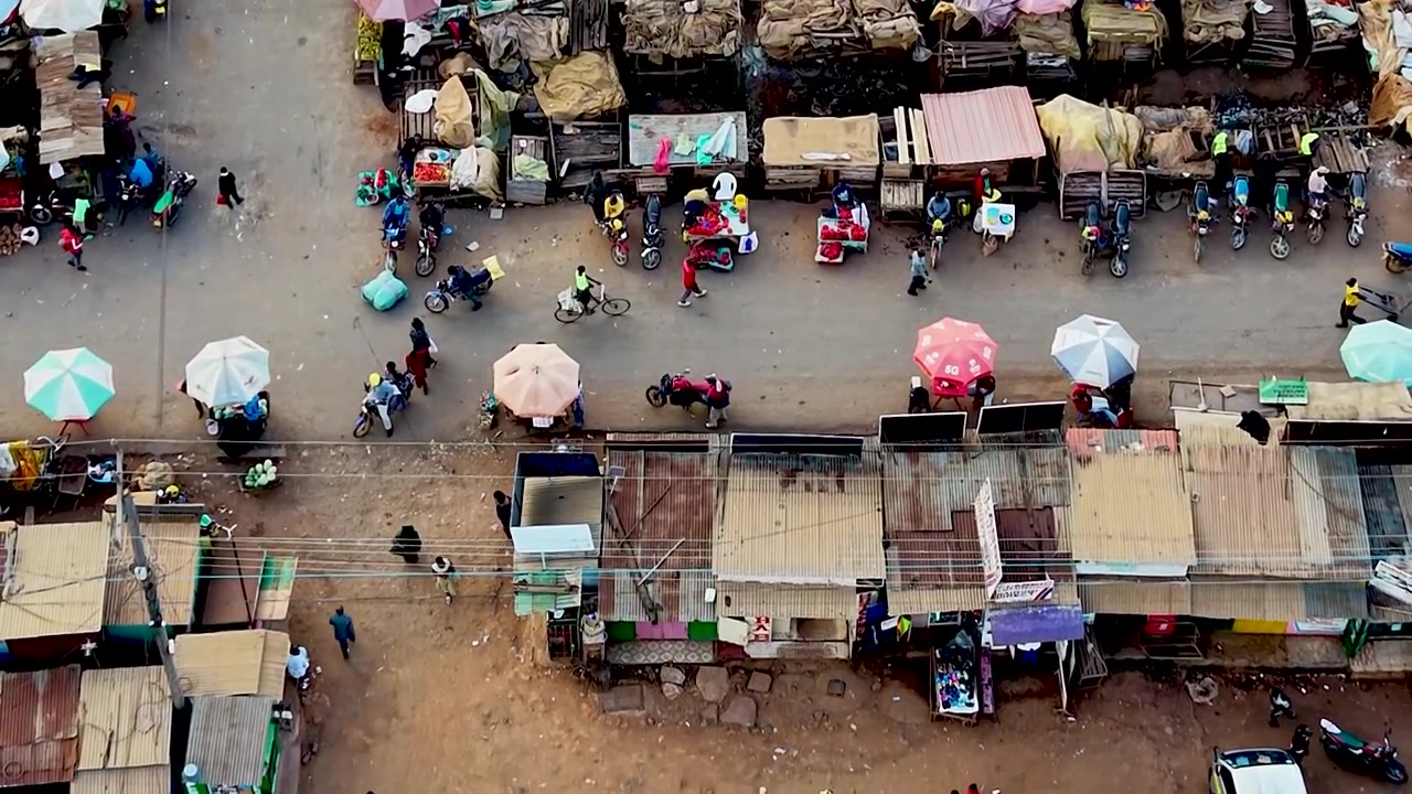 Rural kenya village market Africa poverty poor road infrastructure cars moving on the poor maintained roads in kenya
