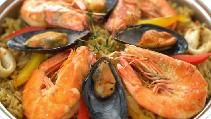Seafood Paella with prawns, clams, mussels on saffron rice - Spanish food style