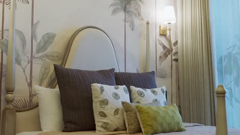 comfy interior of a bedroom with nature wallpaper decor. tilt-up shot