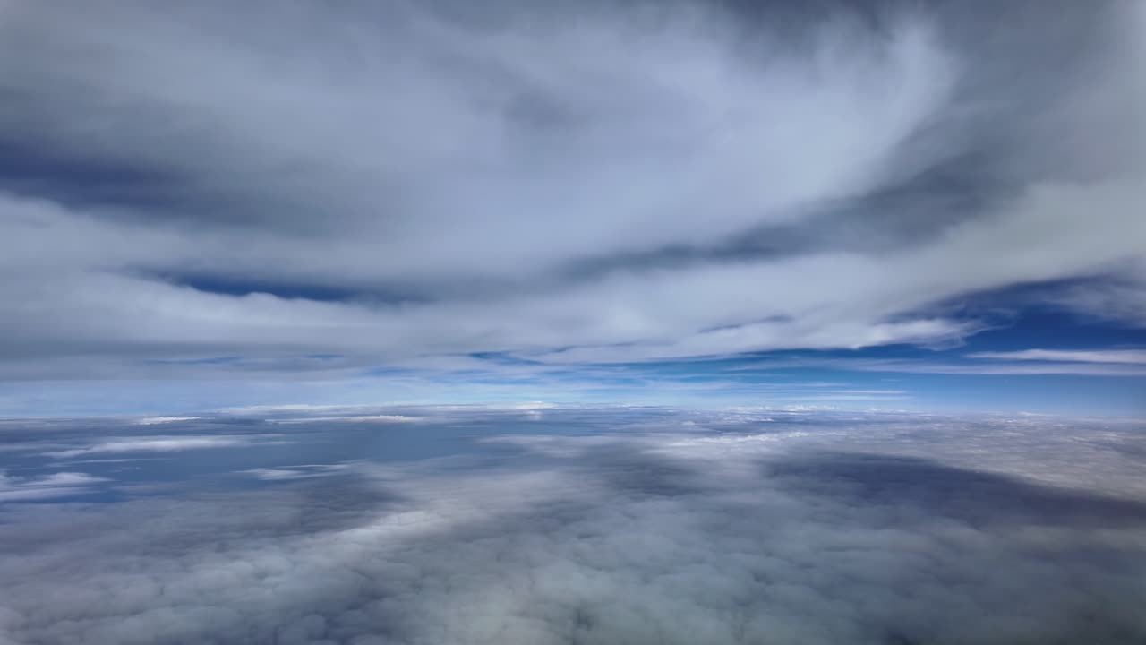 An immersive pilot’s perspective from a jet cockpit while flying peacefully between layers of ethereal stratus clouds at supersonic speed, with ablue horizon ahead