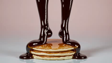 chocolate syrup covered legs on pancakes