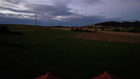 charming countryside house at sunset with distant fields and mountains in cantabria, spain. aerial