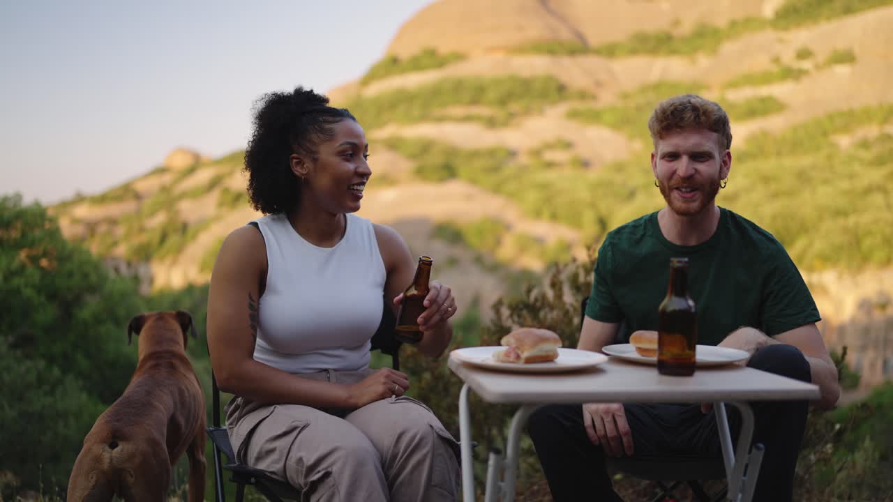 People Having a Picnic with a Dog in the Mountains