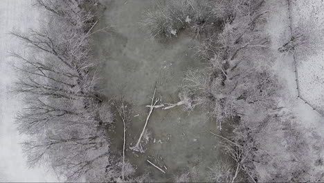 Drone-Flying-Up-Over-Frozen-Pond