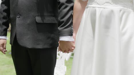 spouses holding hands in a wedding