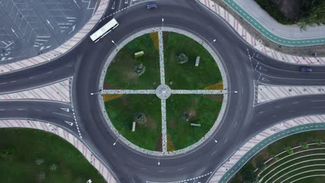 Overhead-rotating-aerial-view-of-a-roundabout-with-dark-grass-in-Salamanca,-Castilla-y-León,-Spain,-Europe