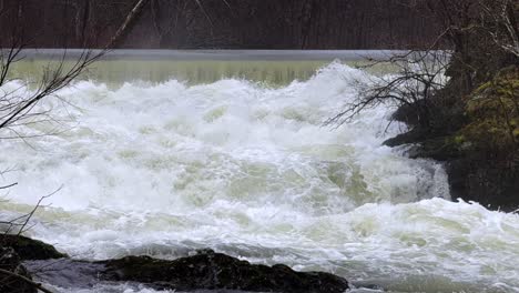 slow motion, strong rapids on a little waterfall after recent snow melt in beacon ny