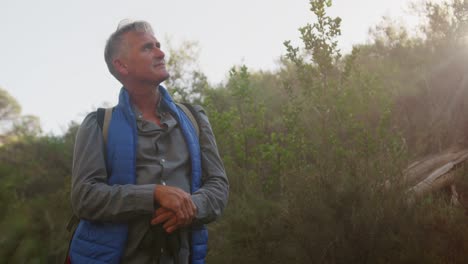 active senior standing in forest