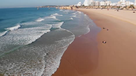 beautiful portimao beach in portugal city coastline - aerial flight