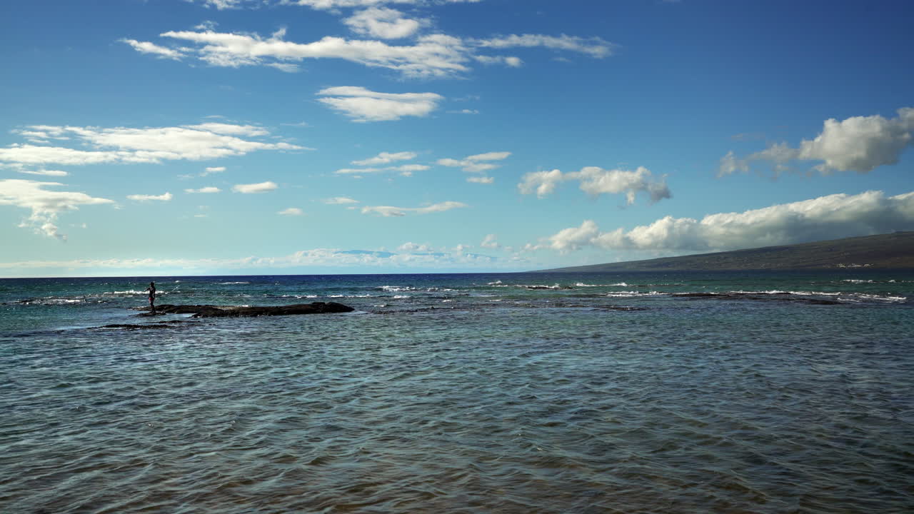 Hawaii Puako Bay Fisherman Casting for Fish with Blue Sky Clouds