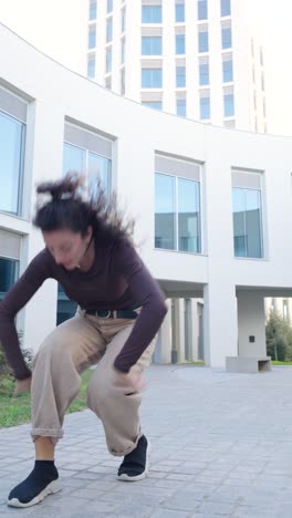 young woman dancing modern choreography outdoors