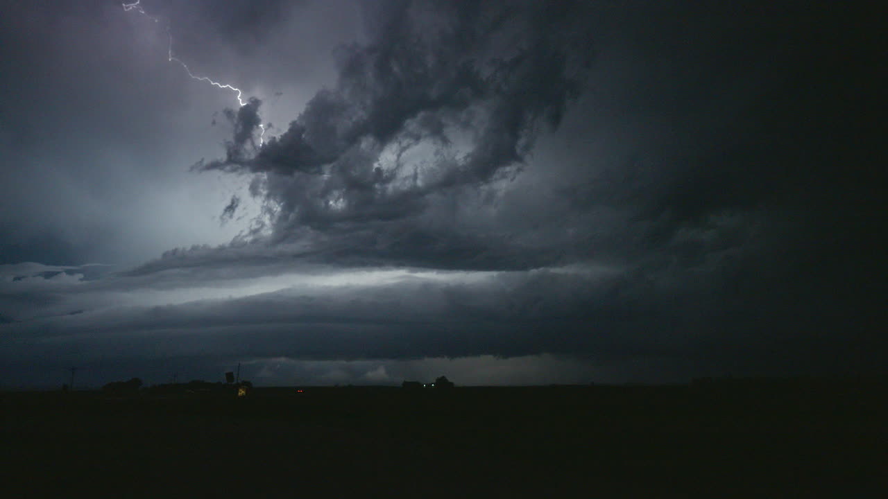 Dazzling lightning bolts light up the sky over a road