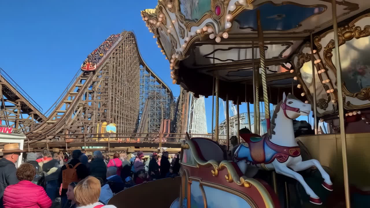 Busy Day at an Amusement Park with Roller Coaster and Carousel Rides