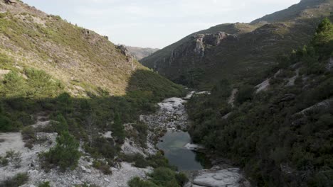 aerial footage of a little river in the mountains valley of peneda geres national park north of portugal