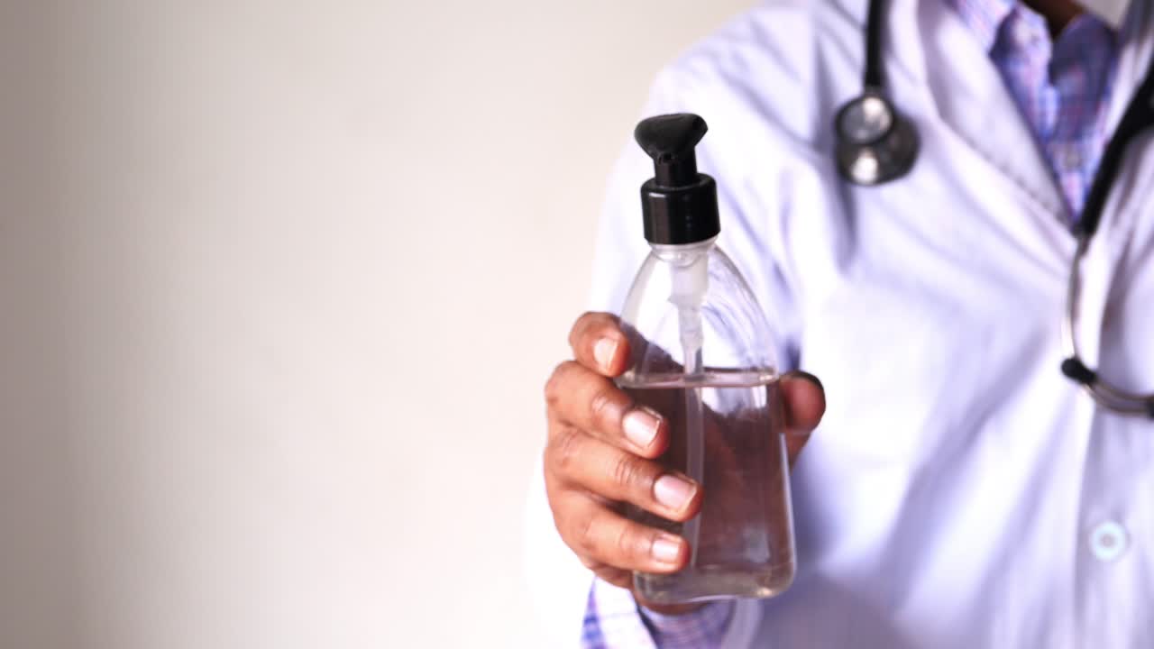 Doctor Holding Hand Sanitizer