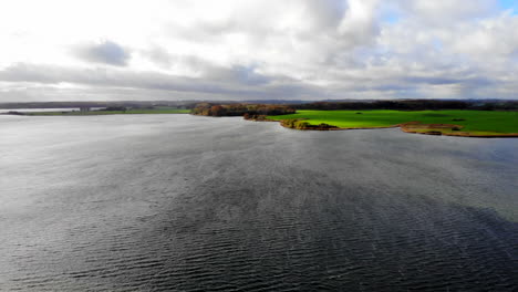 Schlei-sea-and-Northern-Germany-coastline-in-strong-wind,-descending-aerial