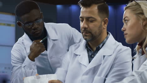 científicos discutiendo la investigación en un laboratorio