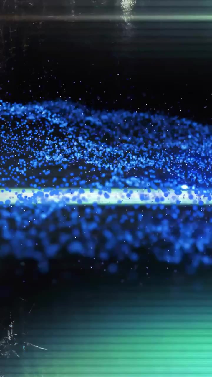 Vertical video: Magenta cubes bursting right causing blue dot wave rippling and adding film grain