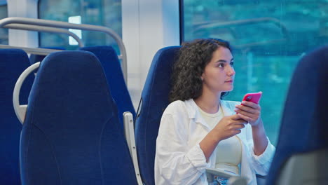 woman using phone on a train