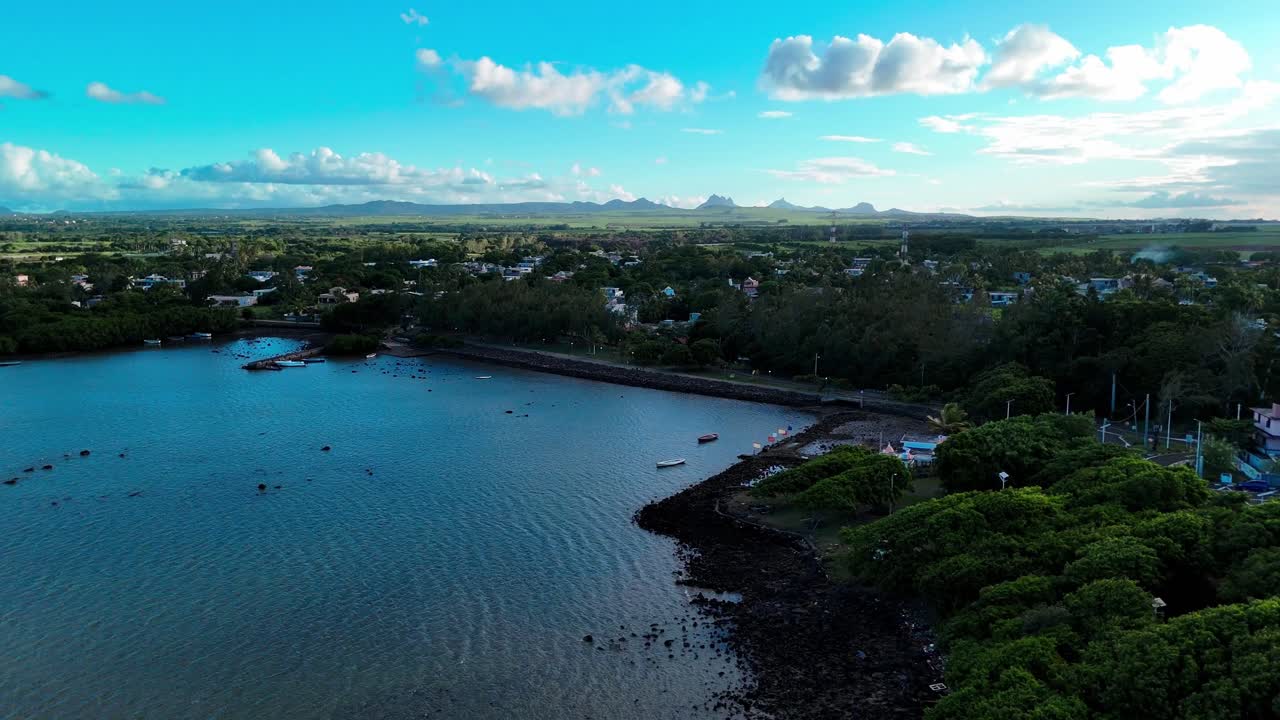 Aerial establishing of Poudre d'Or public beach with palm trees and calm turquoise water, Mauritius