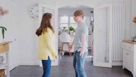 young downs syndrome couple having fun dancing at home together