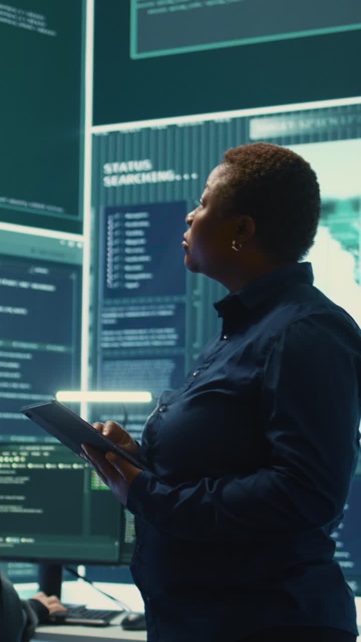 African American Woman Using Tablet in High-Tech Control Room