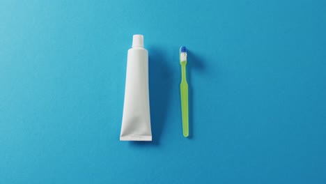 video of close up of toothbrush and paste on blue background