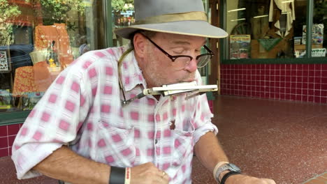 Street-performer-playing-music-on-sidewalk