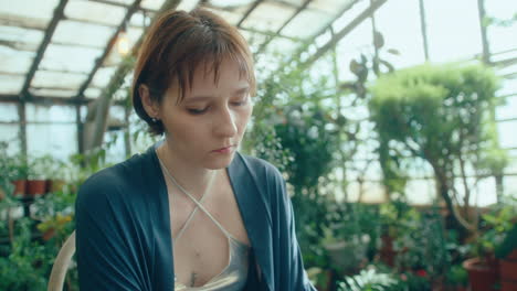 female pianist with jewel-studded hands playing synthesizer in greenhouse