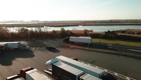 Trucks-coming-at-the-truck-stop-or-service-plaza-between-New-York-and-New-Jersey-on-I-95-aerial-footage-4k