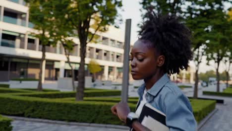 young black woman walking on campus