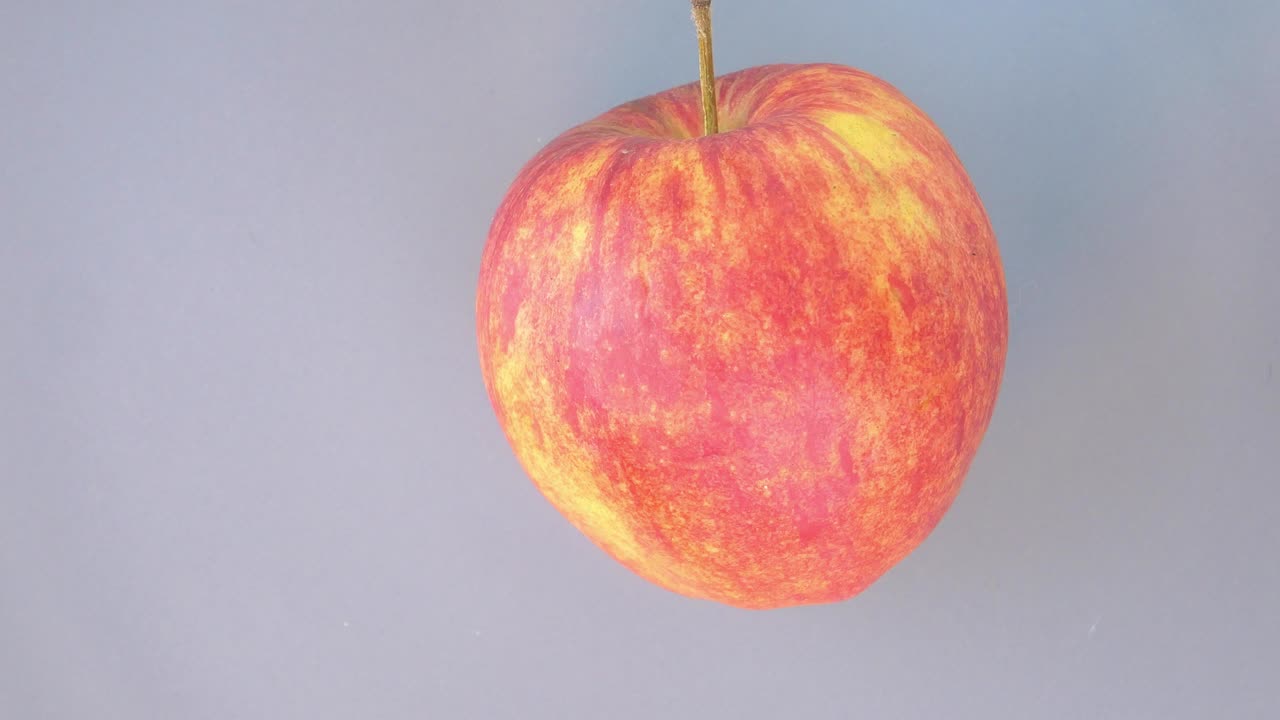 Red apple spins on a plate. Food. Video.