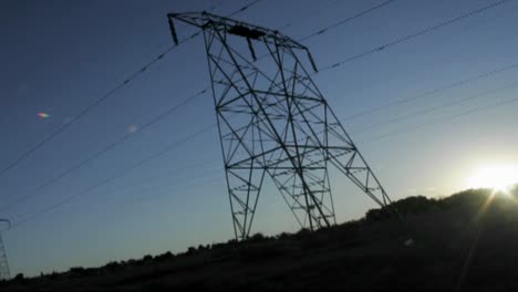 high tension lines against the rising sun