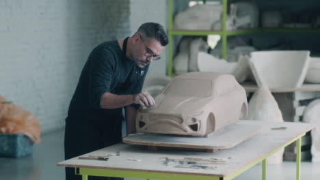 sculpting a car model from clay
