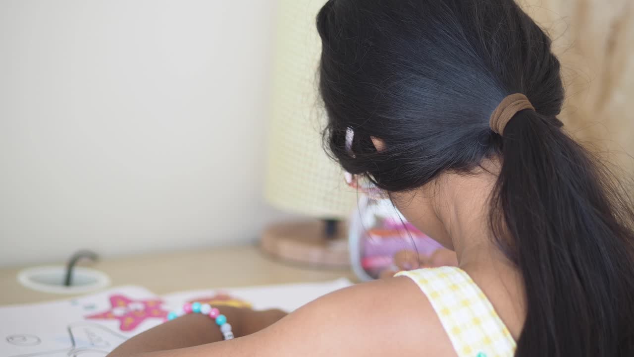 Young child focused on a creative activity like drawing or coloring