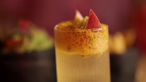 a vibrant passion fruit cocktail garnished with fruit slices, set in a lively bangkok restaurant with warm lighting
