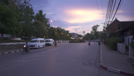 asan traffic late in the afternoon with a scooter passing by