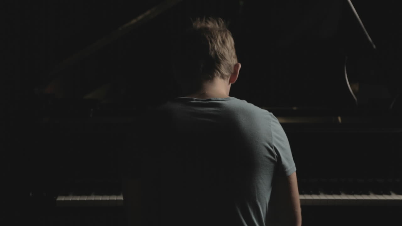 A boy is playing the piano
