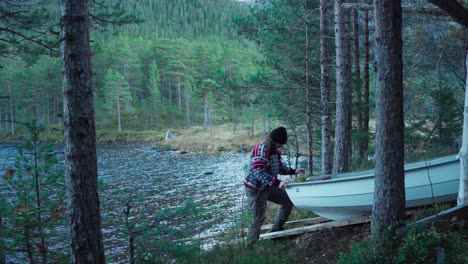 Hildremsvatnet,-Trondelag,-Norway---A-Man-Preparing-His-boat-by-the-Lakeside---Static-Shot