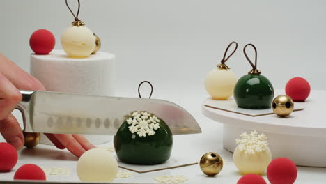 cutting a christmas ornament-shaped dessert