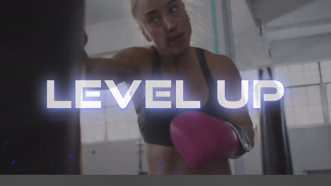 animation of level up text in white over caucasian female boxer training with punch bag