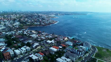 Drone-aerial-of-beautiful-Coogee-coast-headland-landscape-with-housing-rocky-walking-track-point-Randwick-Maroubra-Sydney-city-CBD-Australia