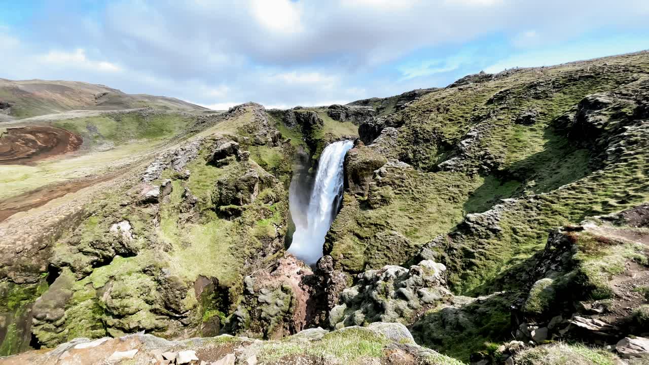 Iceland - Experience the magical allure of Sk&oacute;gafoss waterfall on a picturesque hike through Iceland's terrain
