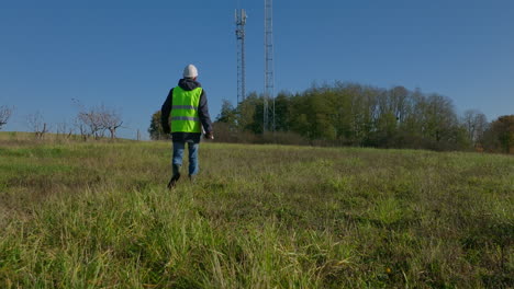 miembro del personal de la empresa caminando hacia el lugar de trabajo en el campo